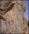 The main group of images pecked into a natural rock face. Each of the figures has horns and a tail apparently representing devils of Byzantine date rather than early prehistoric depictions of animals. The largest image, at the top with horns partly in shadow, is shown in detail on the previous image. No other remains were seen in the immediate vicinity. 